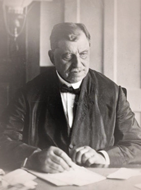 Russell Conwell seated at a desk