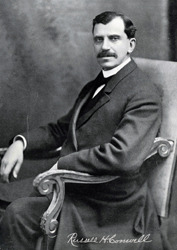 a young Russell Conwell, dressed in a suit, sitting in an upholstered chair, with his signature appearing across the bottom of the photograph