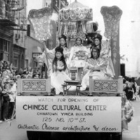 Five women, in traditional Chinese costume, on top of a parade float.